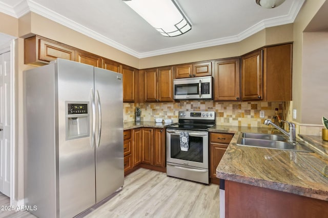 4601 N 102nd Ave Unit 1055, Phoenix, AZ 85037 - kitchen featuring appliances with stainless steel finishes, a sink, brown cabinetry, light wood-style flooring, and ornamental molding