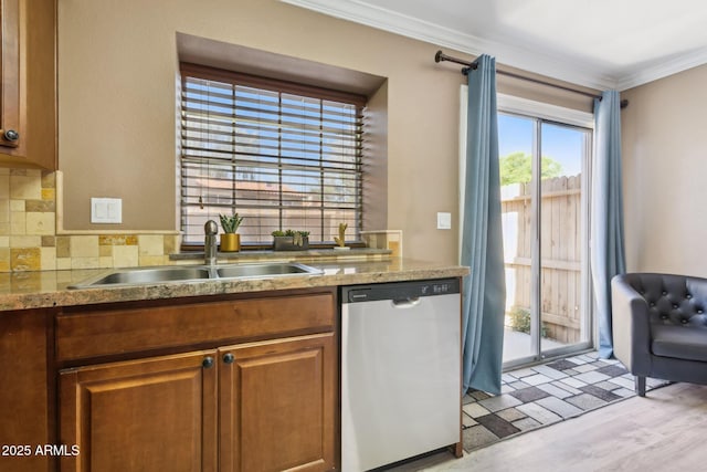 4601 N 102nd Ave Unit 1055, Phoenix, AZ 85037 - kitchen featuring dishwasher, a sink, crown molding, tasteful backsplash, and brown cabinetry