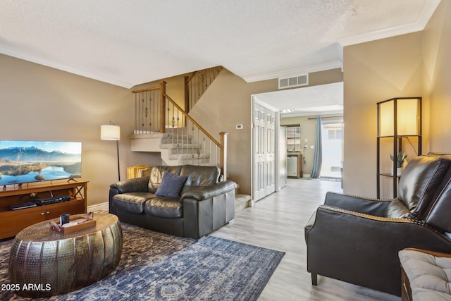 4601 N 102nd Ave Unit 1055, Phoenix, AZ 85037 - living area with ornamental molding, wood finished floors, a textured ceiling, stairs, and baseboards