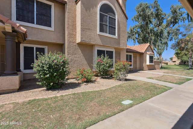 4601 N 102nd Ave Unit 1055, Phoenix, AZ 85037 - view of front of house with stucco siding and a front lawn