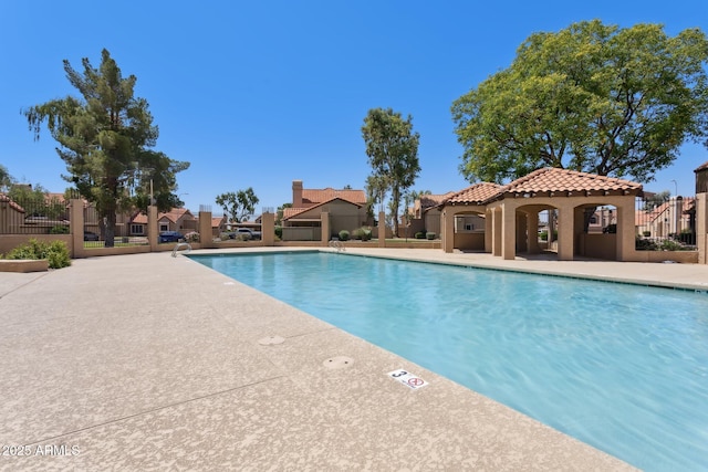 4601 N 102nd Ave Unit 1055, Phoenix, AZ 85037 - community pool featuring a residential view and a patio area
