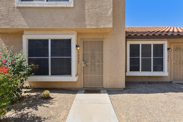 4601 N 102nd Ave Unit 1055, Phoenix, AZ 85037 - view of exterior entry featuring stucco siding and a tile roof