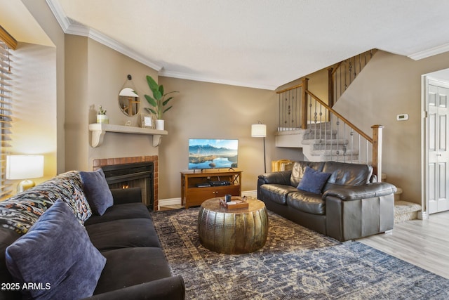 4601 N 102nd Ave Unit 1055, Phoenix, AZ 85037 - living area featuring ornamental molding, stairway, wood finished floors, a lit fireplace, and baseboards