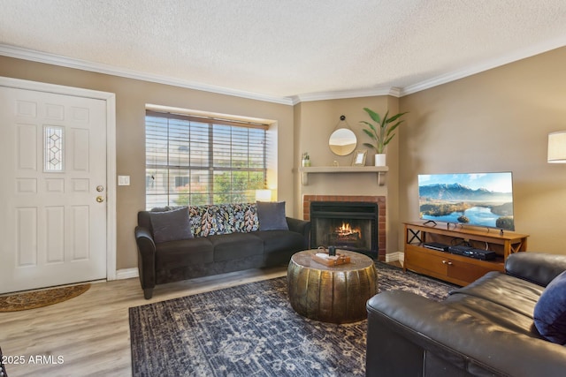 4601 N 102nd Ave Unit 1055, Phoenix, AZ 85037 - living room with ornamental molding, wood finished floors, a brick fireplace, a textured ceiling, and baseboards