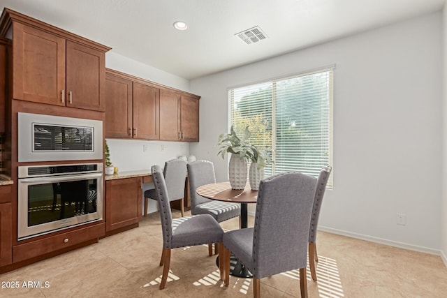 tiled dining area featuring built in desk