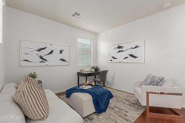 sitting room with hardwood / wood-style flooring