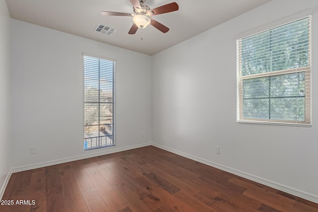 empty room featuring ceiling fan and dark hardwood / wood-style flooring