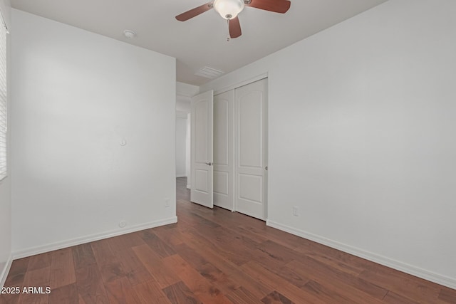 unfurnished bedroom with dark hardwood / wood-style flooring, ceiling fan, and a closet