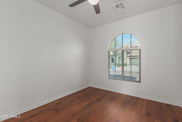 spare room featuring ceiling fan and dark hardwood / wood-style floors