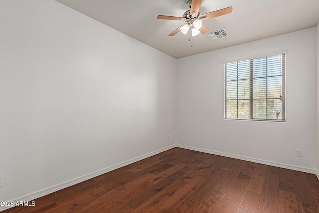 empty room with dark wood-type flooring and ceiling fan