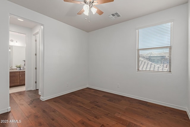 empty room with ceiling fan, dark hardwood / wood-style flooring, and sink