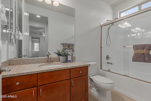 full bathroom featuring enclosed tub / shower combo, vanity, toilet, and tile patterned flooring