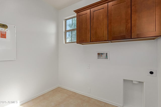 laundry room with cabinets, hookup for an electric dryer, and hookup for a washing machine