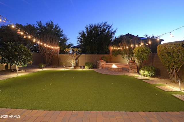 yard at dusk with a fire pit