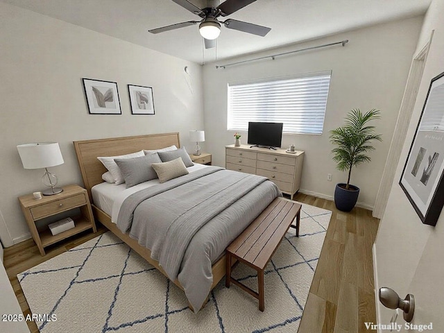 bedroom with ceiling fan and light wood-type flooring