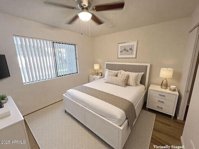 bedroom with ceiling fan and wood-type flooring