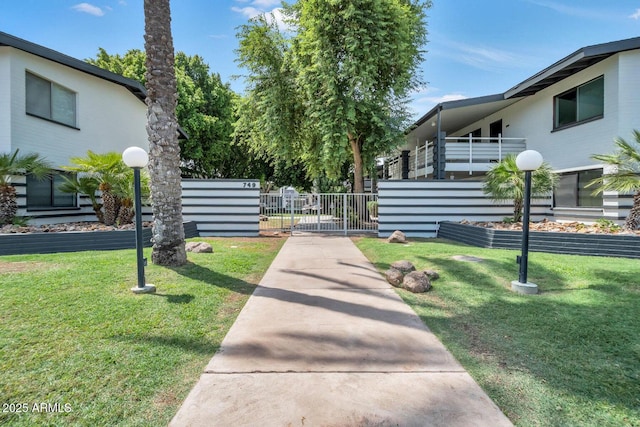 view of property's community featuring a yard