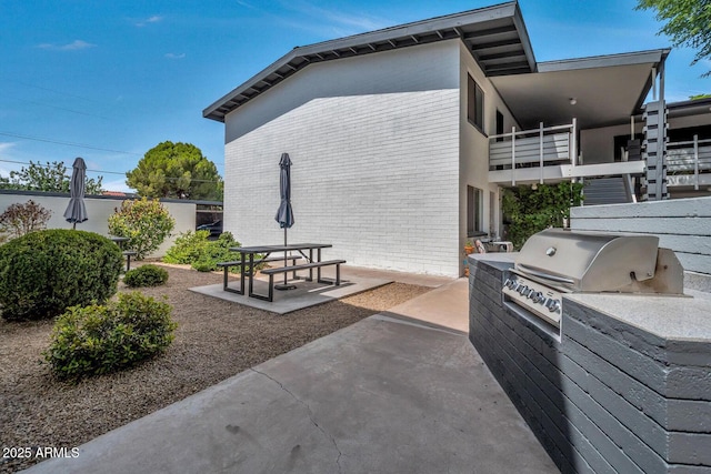 view of patio / terrace featuring a balcony, grilling area, and area for grilling