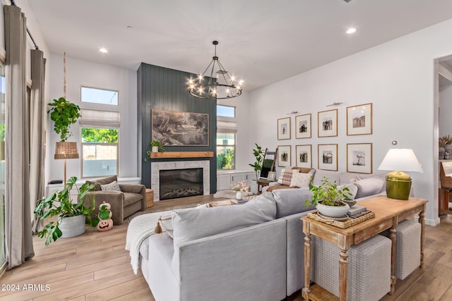 living room featuring light wood-type flooring and a chandelier