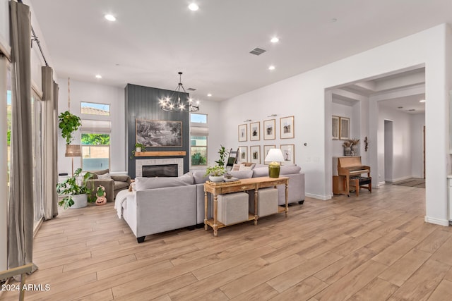 living room featuring an inviting chandelier and light wood-type flooring