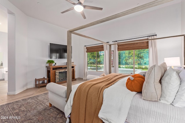 bedroom with ensuite bath, hardwood / wood-style flooring, and ceiling fan