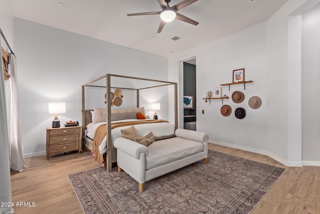 bedroom with ceiling fan and light hardwood / wood-style flooring