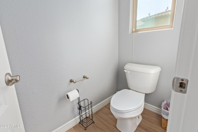 bathroom with hardwood / wood-style floors and toilet