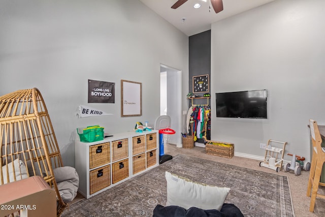 playroom featuring high vaulted ceiling, ceiling fan, and carpet floors