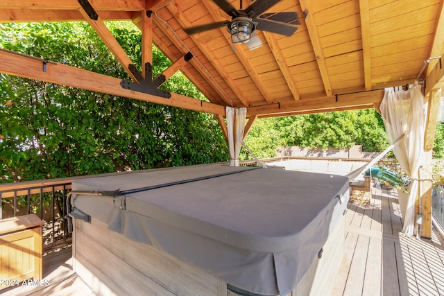 wooden terrace featuring a hot tub and ceiling fan