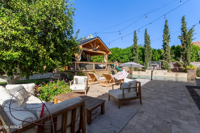 view of patio with outdoor lounge area and a gazebo