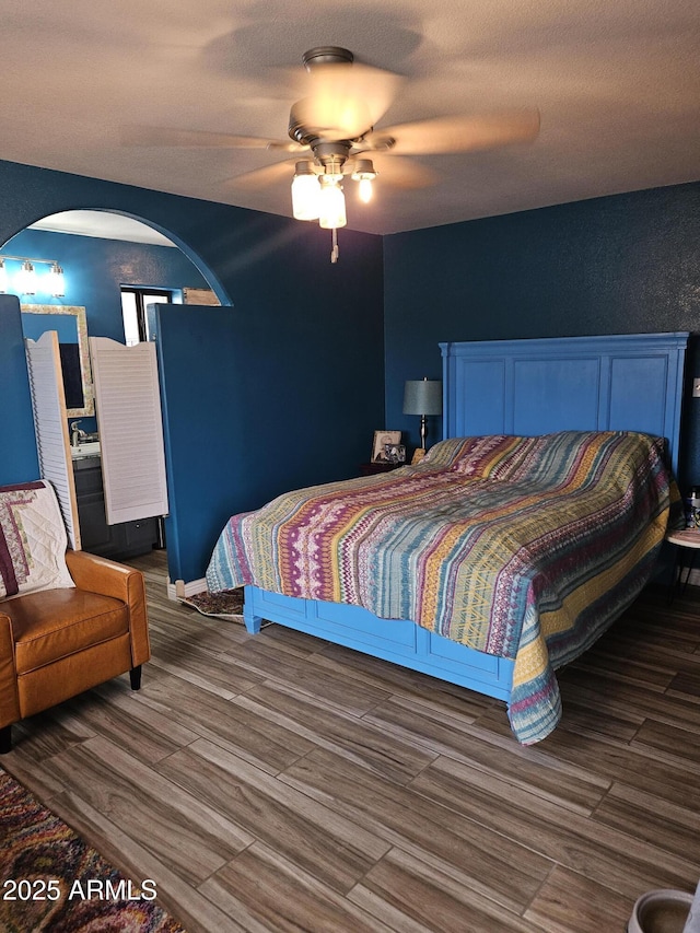 bedroom with dark wood-type flooring and ceiling fan