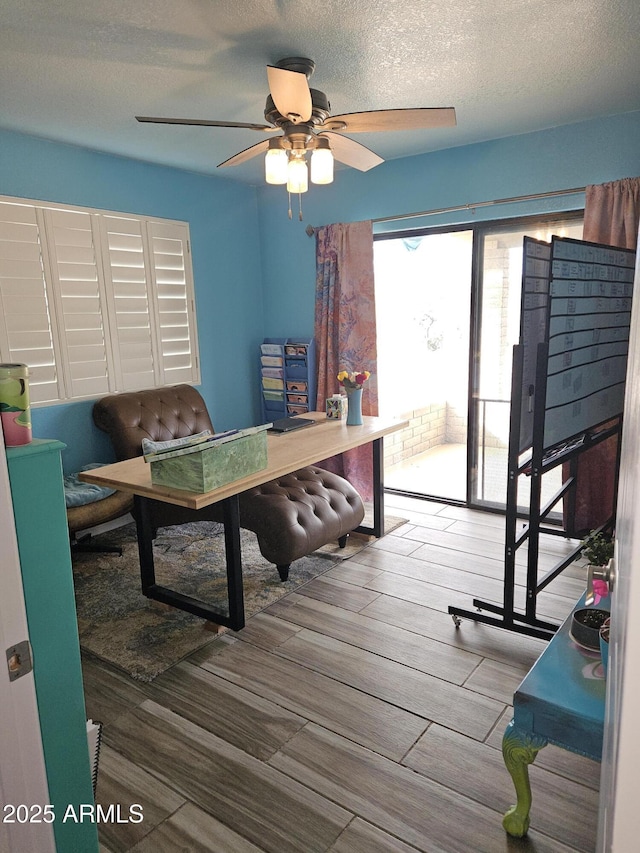 interior space featuring a textured ceiling and ceiling fan