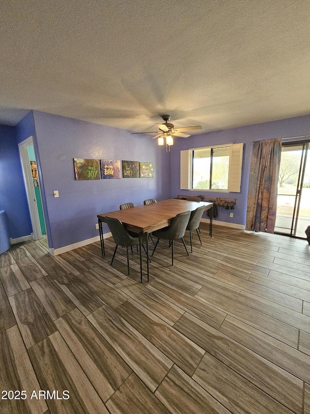 dining area with a textured ceiling and ceiling fan