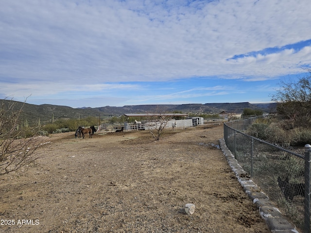 view of yard featuring a rural view and a mountain view