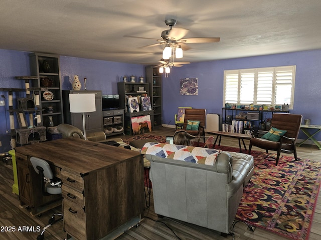 living room with ceiling fan and hardwood / wood-style floors