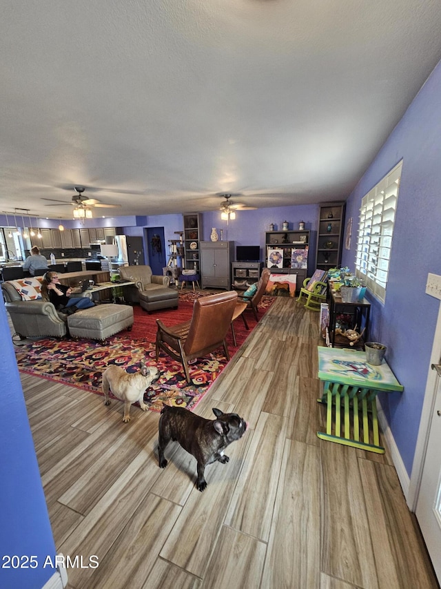 living room with hardwood / wood-style floors and ceiling fan