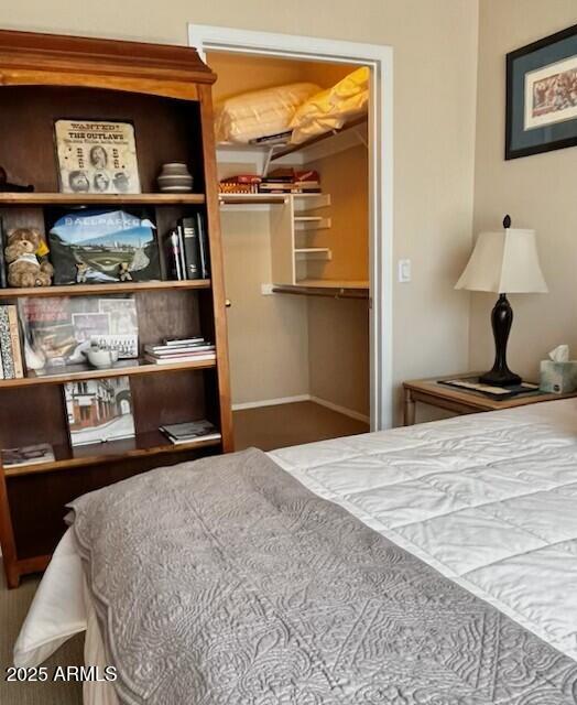 bedroom featuring a closet and baseboards