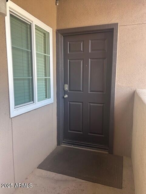 doorway to property with stucco siding