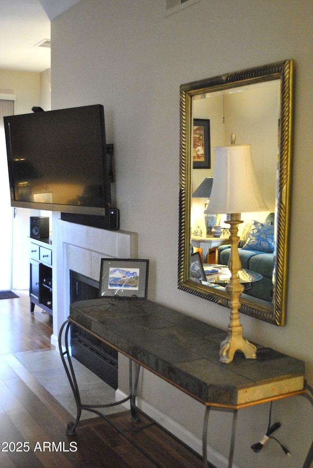 detailed view of wood finished floors and a fireplace