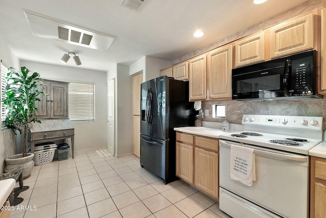 kitchen featuring light brown cabinets, visible vents, light tile patterned flooring, black appliances, and light countertops