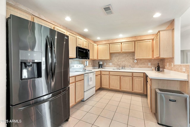 kitchen with light tile patterned floors, light brown cabinets, visible vents, a sink, and stainless steel appliances