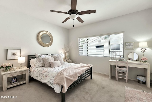 carpeted bedroom featuring baseboards and ceiling fan