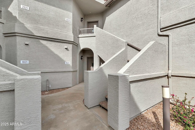 exterior space with stucco siding and a balcony