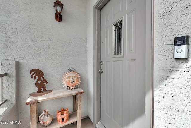 property entrance featuring stucco siding