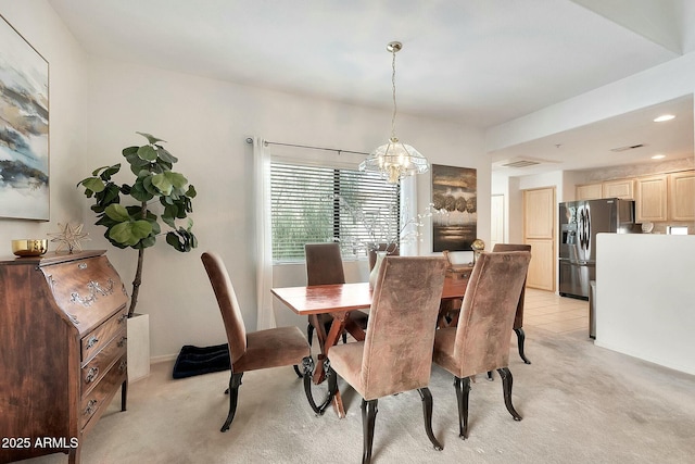 dining space featuring recessed lighting, light colored carpet, and a chandelier