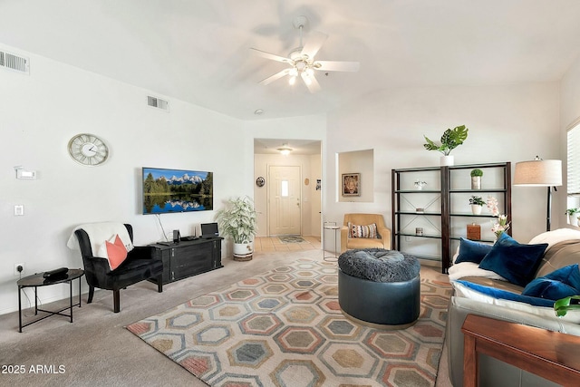 living room featuring visible vents, light colored carpet, and ceiling fan