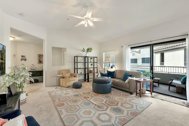 living room featuring light carpet, a ceiling fan, and vaulted ceiling