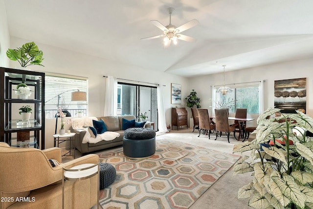 living area with ceiling fan, lofted ceiling, and light carpet