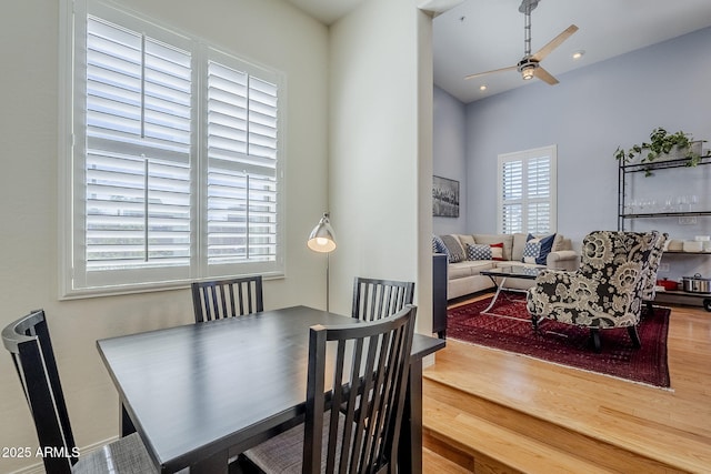 dining area with ceiling fan and wood finished floors