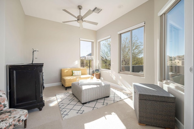 interior space with light carpet and ceiling fan